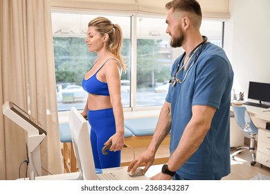 Male therapist conducting neurological exam to female with special devices - Shutterstock ID 2368343287