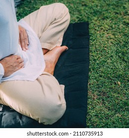 Male Therapist Performing Reiki Therapy Self-treatment Holding Hands Over His Stomach. Alternative Therapy Concept. 