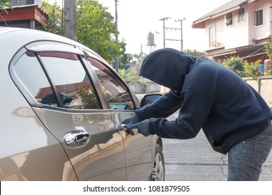 Male Thief Tries To Steal A Car. Car Theft Concept