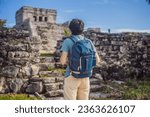 Male tourist enjoying the view Pre-Columbian Mayan walled city of Tulum, Quintana Roo, Mexico, North America, Tulum, Mexico. El Castillo - castle the Mayan city of Tulum main temple