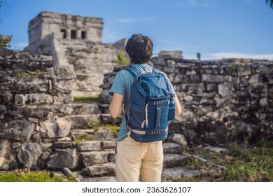 Male tourist enjoying the view Pre-Columbian Mayan walled city of Tulum, Quintana Roo, Mexico, North America, Tulum, Mexico. El Castillo - castle the Mayan city of Tulum main temple