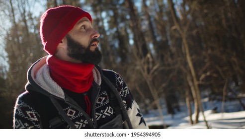 Male Tourist Got Lost In Forest In Winter. Portrait Of Stressed Young Man Lost In Winter Woods During Hiking Looking Around Trying To Find Way Out