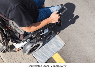 Male tourist on wheelchair crossing over the threshold ramp on the seaside promenade. Disability and accessible tourism concepts. - Powered by Shutterstock