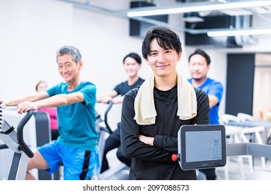 Male Trainer Working At Gym