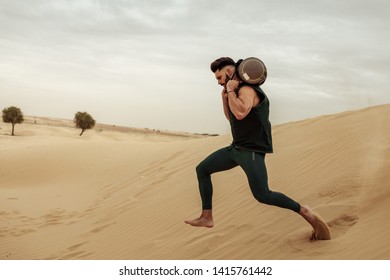 Male Training With Sandbag In The Desert