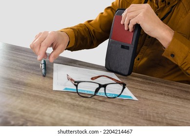 Male Traveller Filling Travel Insurance Claim Application Form, Studio, Light Gray Background