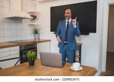 Male Tutor Presenting Something To The Onlinde Audience