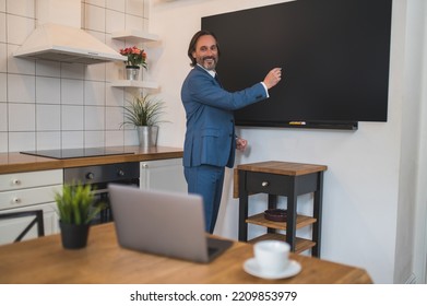 Male Tutor Presenting Something To The Onlinde Audience