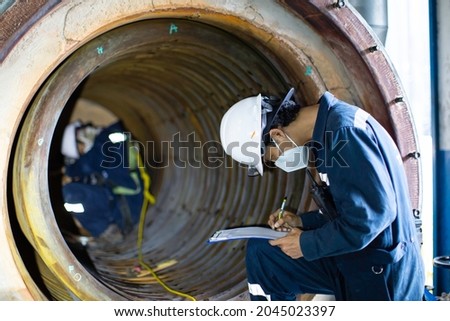Male two worker inspection measured the coil pipe circular thickness of the boiler scan minimum thickness into danger confined space.
