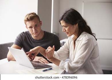 Male University Student Working One To One With Tutor