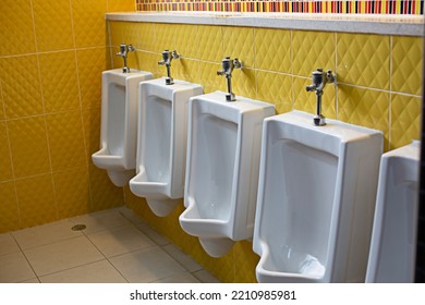 Male Urinal In Yellow Wall Toilet