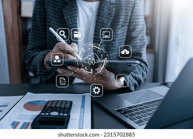 Male is using a tablet to access the cloud computing system , Storage and data transfer Cloud network , Cloud technology. Networking and internet service concept. - Shutterstock ID 2315702885