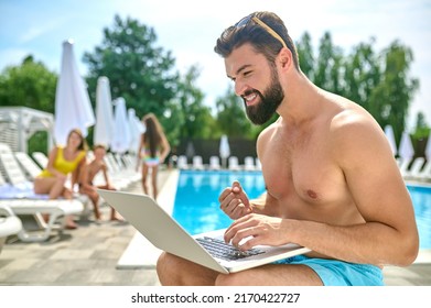 Male Vacationer With His Computer At The Resort