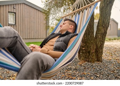 Male Vacationer Sleeping In The Hammock Outdoors