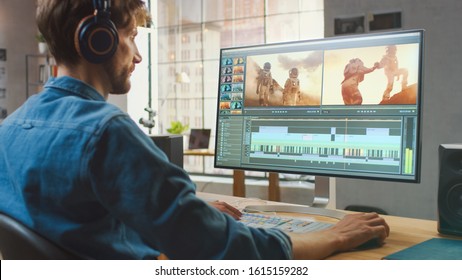 Male Video Editor in Headphones Working with Footages on His Personal Computer with Big Display. He Works in a Cool Office Loft. Creative Man Wears a Jeans Shirt. - Shutterstock ID 1615159282