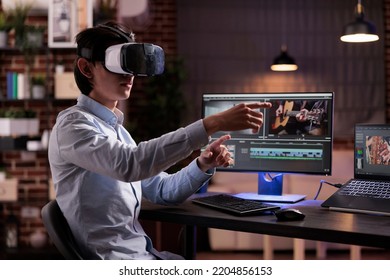 Male videographer editing movie montage with virtual reality glasses, using multimedia production software to create footage. Edit with color grading and visual effects, working with vr goggles. - Shutterstock ID 2204856153