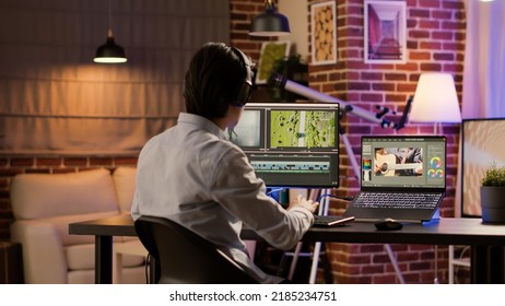 Male videographer working with color gradient software to edit video for professional film montage on computer. Editing movie footage with sound and visual effects to create multimedia content. - Shutterstock ID 2185234751