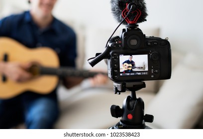 Male vlogger recording music related broadcast at home