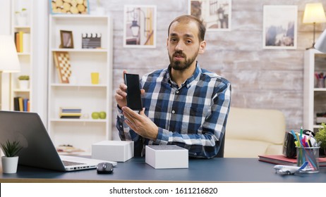 Male Vlogger Recording The Unboxing Of New Phone. Famous Content Creator.