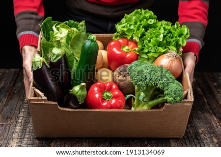A male volunteer delivers food and vegetables to people in quarantine. Home insulation concept. Food delivery for people. Pandemic COVID-19 concept