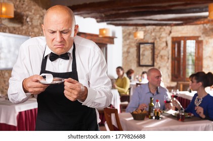 Male Waiter Demonstrating His Upset With Little Tips From Restaurant Visitors