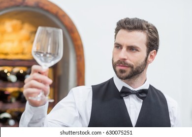 Male Waiter Holding Empty Wine Glass In The Restaurant