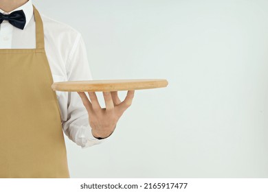 Male Waiter Holds Empty Tray On Light Background
