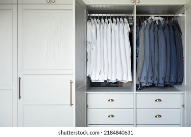 Male Wardrobe Furniture For Business Clothing Neatly Storage Organization. Man Closet With Hanging Elegance Garment Attire White Shirt And Blazer Coat On Hangers. Contemporary Dress Room Interior