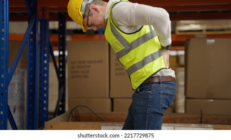 Male warehouse engineer manager suffering from back injury during checking stock working at warehouse factory, Storage worker having back pain at work - Powered by Shutterstock