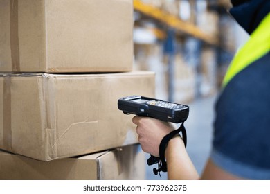 Male Warehouse Worker With Barcode Scanner.