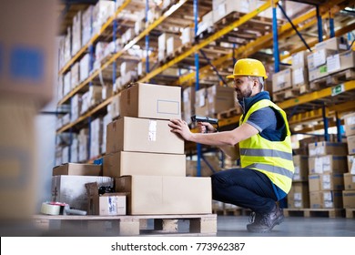 Male Warehouse Worker With Barcode Scanner.