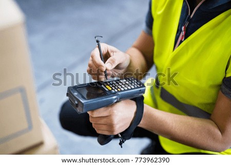 Male warehouse worker with barcode scanner.