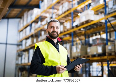 Male Warehouse Worker With Clipboard.