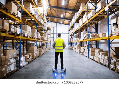 Male warehouse worker on hoverboard. - Powered by Shutterstock