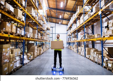 Male warehouse worker on hoverboard. - Powered by Shutterstock