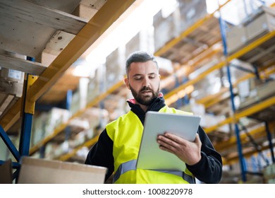 Male Warehouse Worker With Tablet.