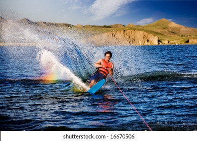 A Male Waterskiing On A Beautiful Lake