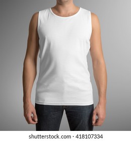 Male wearing white tank top shirt, isolated on gray background, with clipping path to change background
