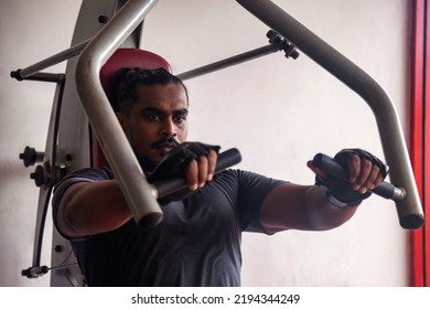 Male Weight Training Doing. Sport And Bodybuilding Concept. Sportsman Doing Exercises At Old Gym. Athletic Asian Man Pumping Up Muscles Workout. Young Sri Lankan Bodybuilder Man Training At Gym