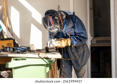 Male welder working on construction site, worker builder making weld - Powered by Shutterstock