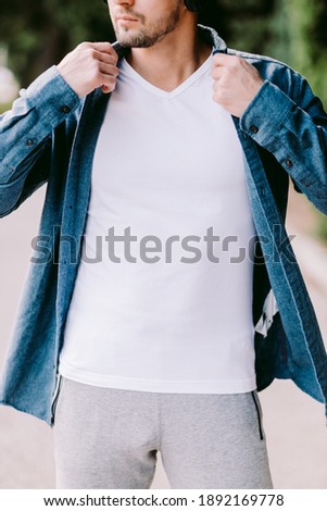 Similar – Frau mit Jeansjacke, blauer Bluse und silberner Armbanduhr.