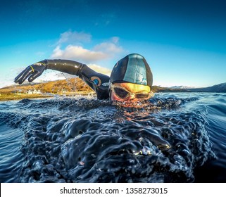 Male Wild Swim In Wetsuit Action Shot To Camera 