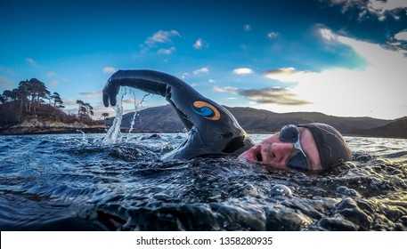 Male Wild Swim Wetsuit Action Show With Trees In Distance