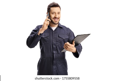 Male worker in a blue uniform talking on a mobile phone and holding a clipboard isolated on white background - Powered by Shutterstock