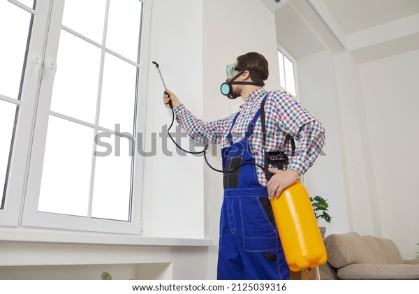 Male\
worker with chemicals disinfect client home from insecticide. Man\
specialist from pest control service spray liquid protect customer\
house from cockroach or insect. Maintenance\
concept.