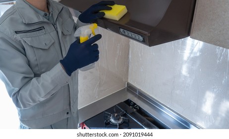 A male worker cleaning the kitchen.