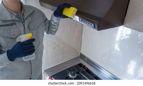 A Male Worker Cleaning The Kitchen.