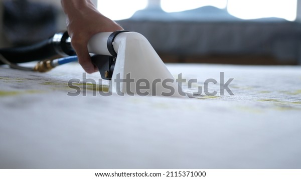 Male Worker Cleaning a mattress With Vacuum\
Cleaner.Professionally extraction method. Upholstered furniture.\
Mattress chemical\
cleaning.