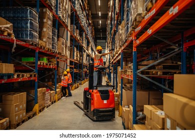 Male worker with face mask scanning bar-code on package boxes while driving forklift - Shutterstock ID 1975071452