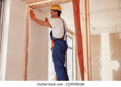 Male Worker Hanging Wallpaper On The Wall